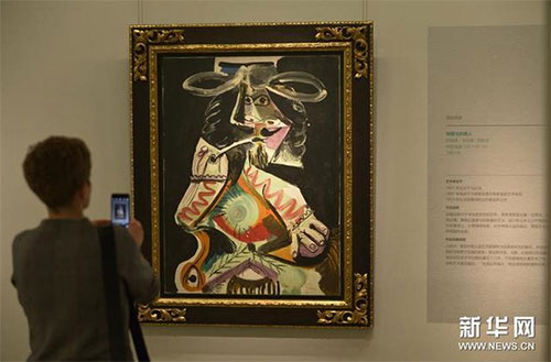 3月20日，观众在中国美术馆参观毕加索的作品《抽烟斗的男人》。（图片来源：新华网  新华社记者 鲁鹏 摄）